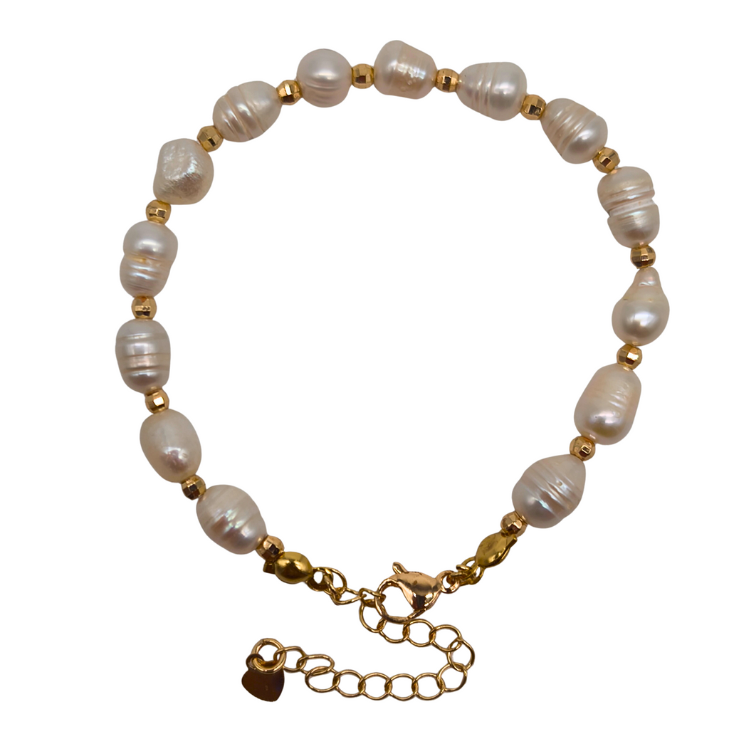 Embrace effortless elegance with this handcrafted pearl strand bracelet. Featuring luminous freshwater pearls delicately accented by minimalist gold bead spacers, this piece is 100% handcrafted in the Philippines by local artisans. Made with high-grade non-tarnish materials, it maintains its rich golden luster even through daily wear. Because natural freshwater pearls are used, every single piece is completely unique, carrying its own distinct shape, size, and luminous sheen.