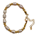 A gold-plated beaded bracelet featuring irregular white freshwater pearls, displayed on a clean white background.